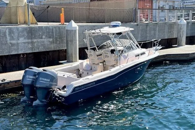 Slide: The Image of 2014 Grady-White Journey 258 boat docked with twin Yamaha engines. - 2