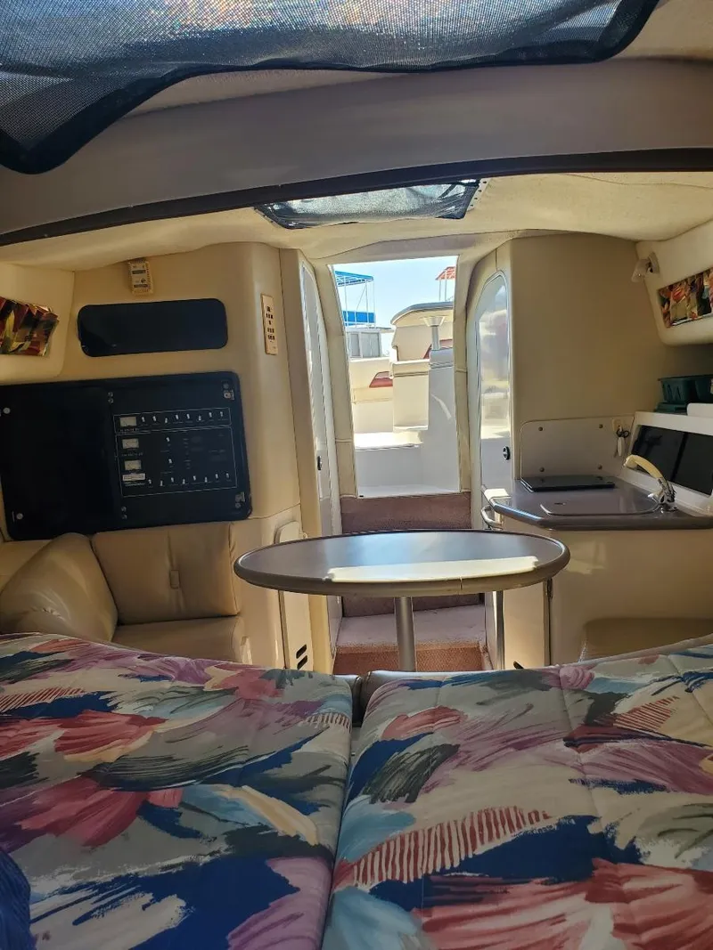 Slide: The Image of 1997 Chaparral Signature 29 cabin interior with seating, table, and kitchenette. - 10