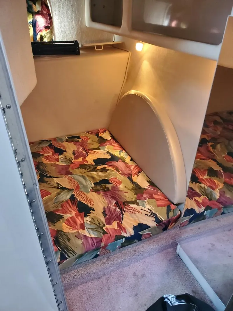 Slide: The Image of 1997 Chaparral Signature 29 cabin interior with colorful bedding. - 13