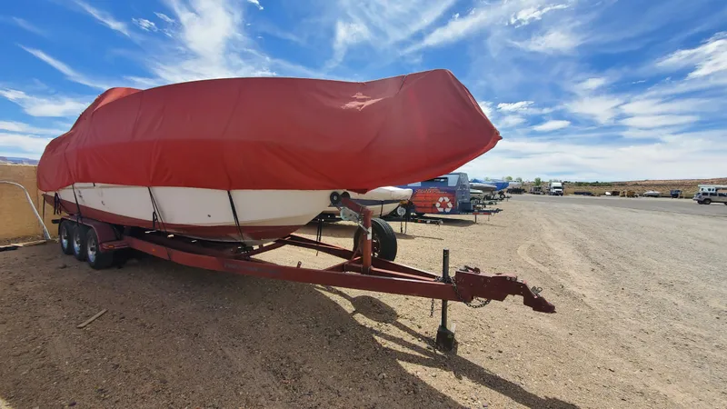 Slide: The Image of 1997 Chaparral Signature 29 boat covered with a red tarp on a trailer. - 14