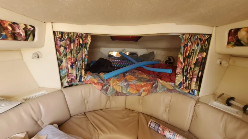Slide: The Image of Interior cabin of a 1997 Chaparral Signature 29 boat with colorful curtains and seating. - 16