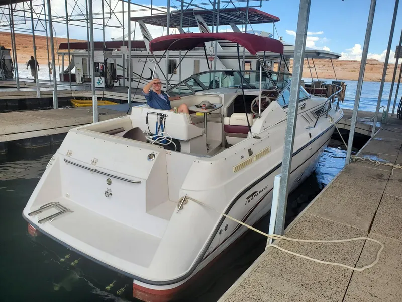 Slide: The Image of 1997 Chaparral Signature 29 boat docked with a person onboard. - 2