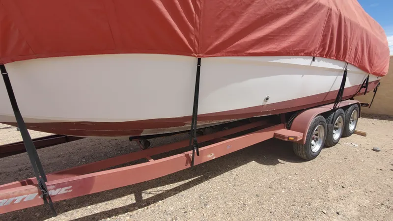Slide: The Image of 1997 Chaparral Signature 29 boat on a trailer with a red cover. - 25