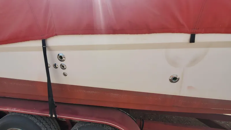 Slide: The Image of 1997 Chaparral Signature 29 boat with red cover on trailer. - 26