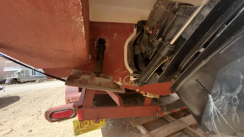 Slide: The Image of 1997 Chaparral Signature 29 boat on trailer, showing propeller and stern drive. - 27