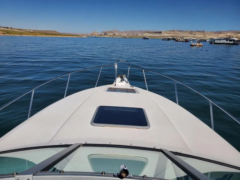 Slide: The Image of 1997 Chaparral Signature 29 boat on a calm lake with distant shoreline. - 3