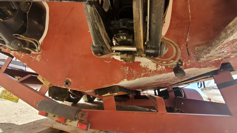 Slide: The Image of 1997 Chaparral Signature 29 boat hull on trailer, showing wear and mechanical parts. - 33