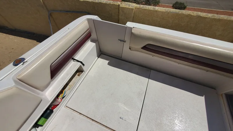 Slide: The Image of Interior view of a 1997 Chaparral Signature 29 boat with white and maroon seating. - 38