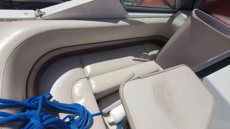 Slide: The Image of 1997 Chaparral Signature 29 boat interior with beige seating and blue rope. - 45