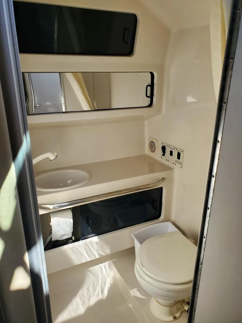 Slide: The Image of 1997 Chaparral Signature 29 boat bathroom with sink, mirror, and toilet. - 7