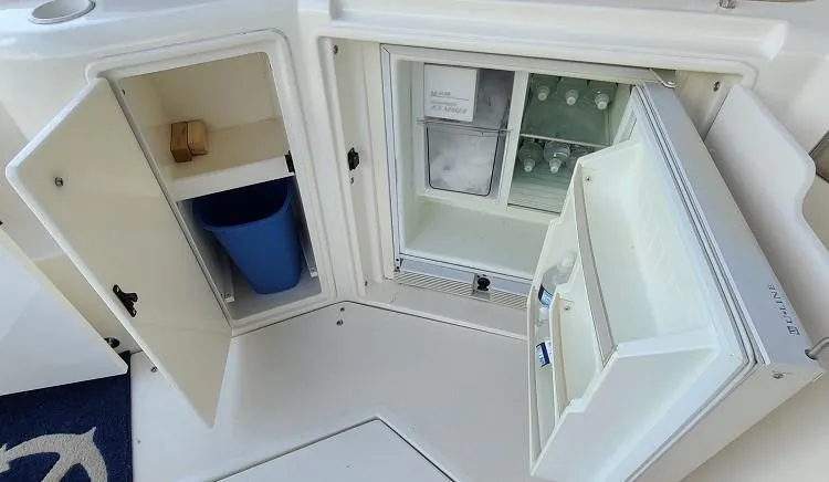 Slide: The Image of 2000 Cruisers Yachts 3870 Express interior with open fridge and storage compartment. - 12
