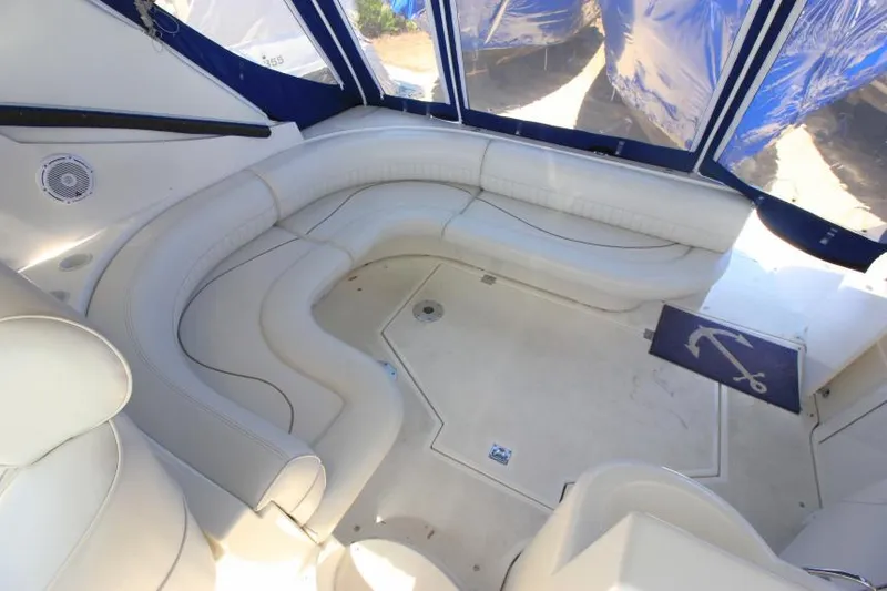 Slide: The Image of 2000 Cruisers Yachts 3870 Express interior with white seating and blue accents. - 13