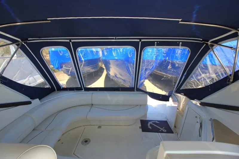 Slide: The Image of 2000 Cruisers Yachts 3870 Express interior with blue canopy and white seating. - 14