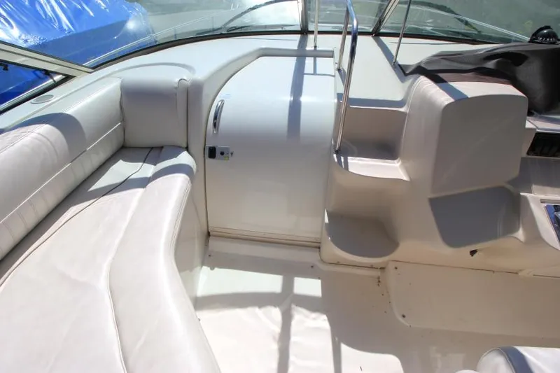 Slide: The Image of 2000 Cruisers Yachts 3870 Express interior with white seating and helm area. - 18