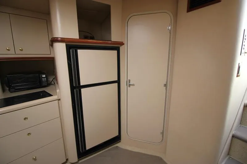 Slide: The Image of Interior of 2000 Cruisers Yachts 3870 Express with kitchenette and storage. - 21