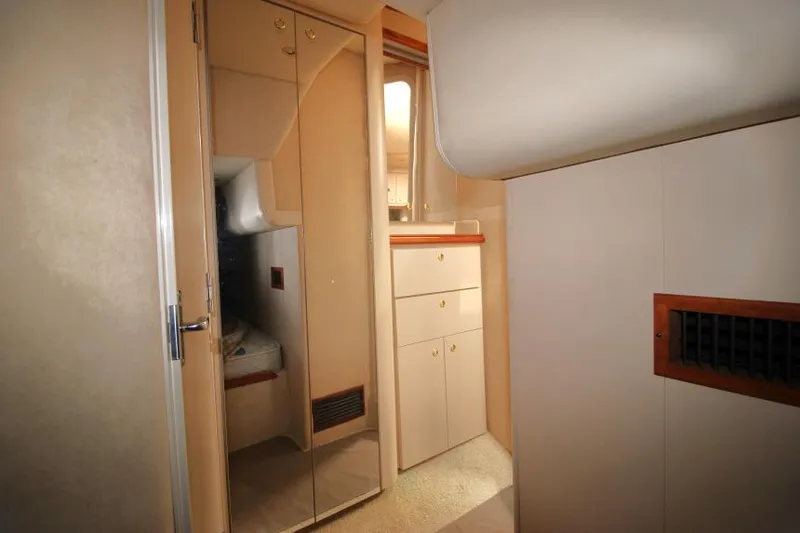 Slide: The Image of 2000 Cruisers Yachts 3870 Express interior with mirrored closet and storage cabinets. - 31