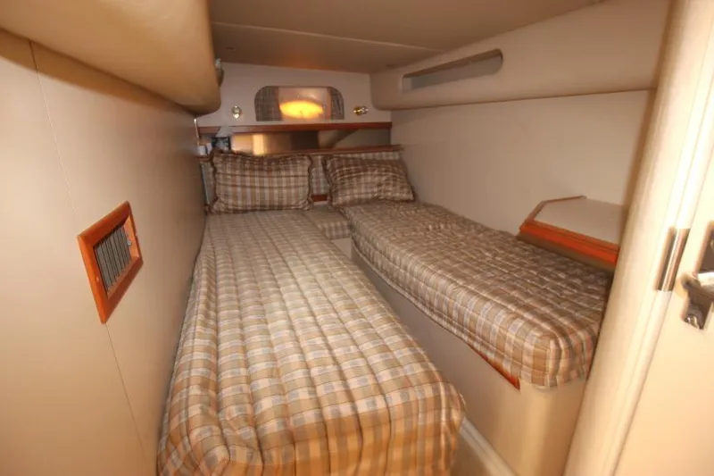 Slide: The Image of 2000 Cruisers Yachts 3870 Express cabin with twin beds and plaid bedding. - 32