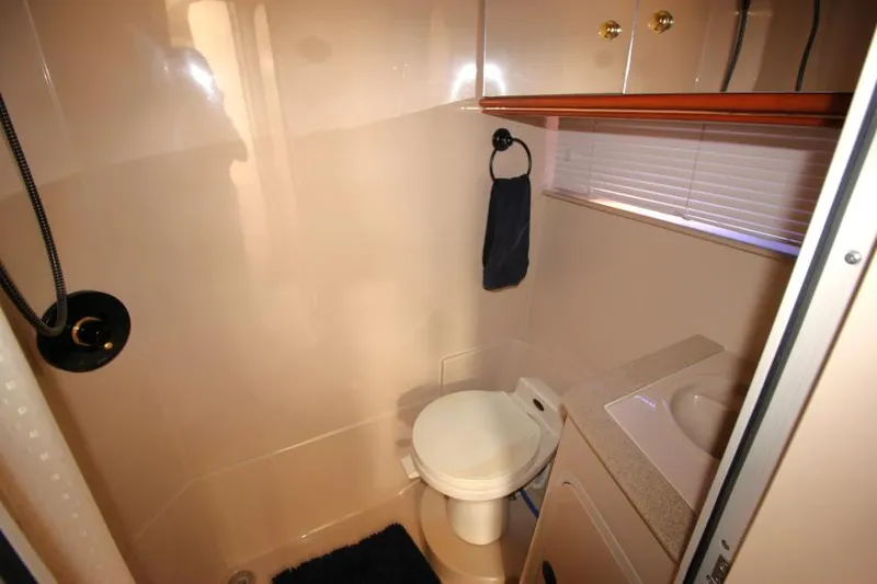 Slide: The Image of Bathroom interior of 2000 Cruisers Yachts 3870 Express, featuring toilet and sink. - 33