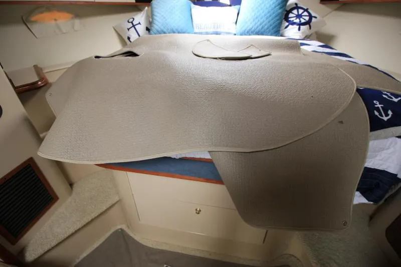 Slide: The Image of Interior of 2000 Cruisers Yachts 3870 Express with nautical-themed bedding and carpet. - 35