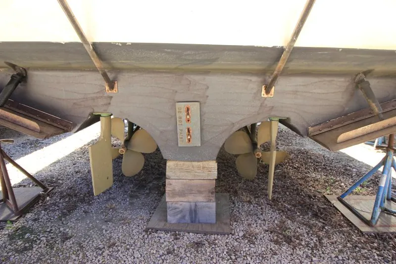 Slide: The Image of 2000 Cruisers Yachts 3870 Express boat underside with dual propellers and supports. - 6