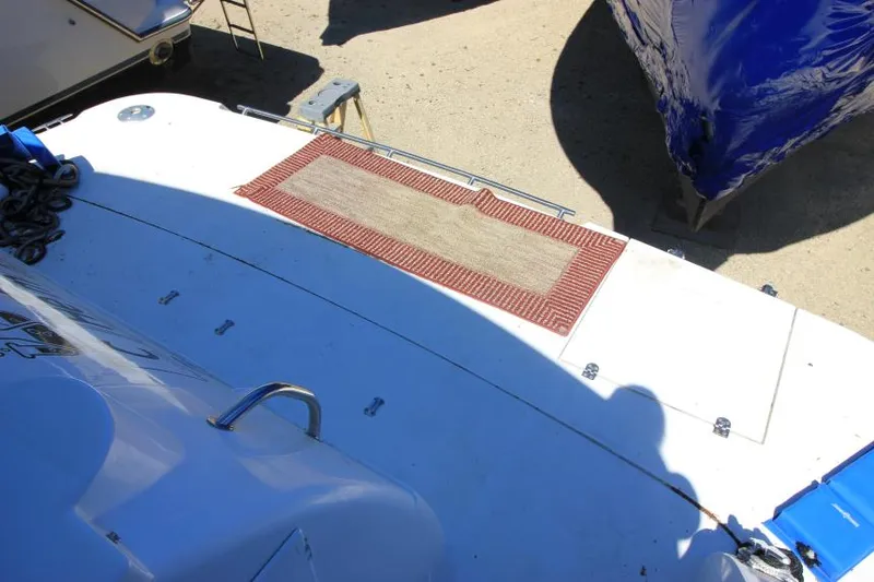 Slide: The Image of 2000 Cruisers Yachts 3870 Express boat deck with a red-bordered mat. - 7