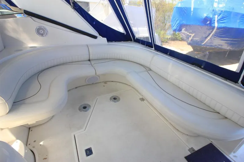 Slide: The Image of 2000 Cruisers Yachts 3870 Express interior with white seating and blue accents. - 8