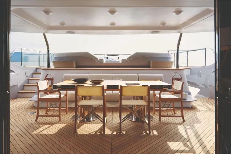 Slide: The Image of Luxurious dining area on the 2023 Azimut Trideck yacht with wooden flooring. - 17