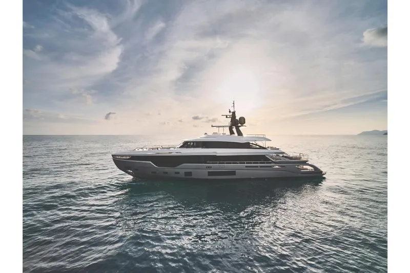 Slide: The Image of 2023 Azimut Trideck yacht cruising on open water at sunset. - 2