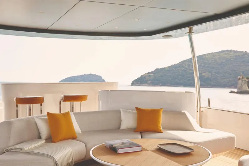Slide: The Image of Luxurious 2023 Azimut Trideck yacht interior with scenic ocean view, modern seating, and stylish decor. - 28