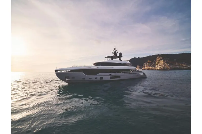 Slide: The Image of 2023 Azimut Trideck yacht on calm waters at sunset. - 3