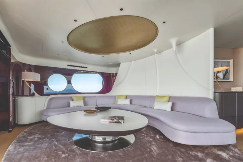 Slide: The Image of Luxurious interior of 2023 Azimut Trideck yacht with modern curved sofa and round table. - 34