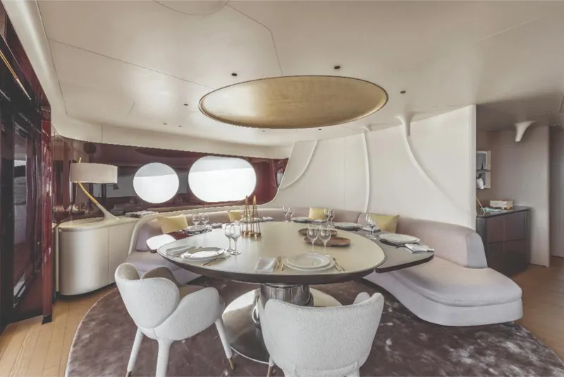 Slide: The Image of Luxurious dining area on the 2023 Azimut Trideck yacht with modern furnishings. - 38