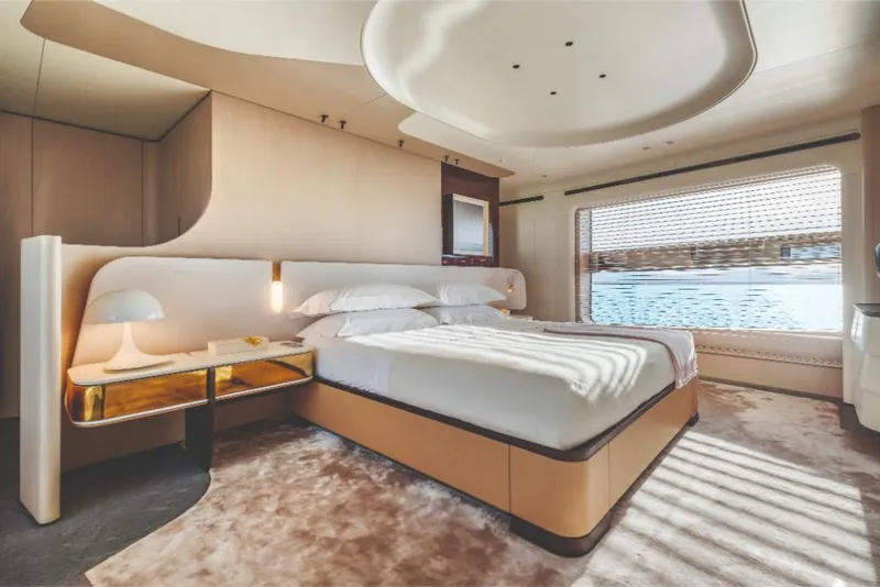 Slide: The Image of Luxurious bedroom interior of 2023 Azimut Trideck yacht with large window and modern design. - 42