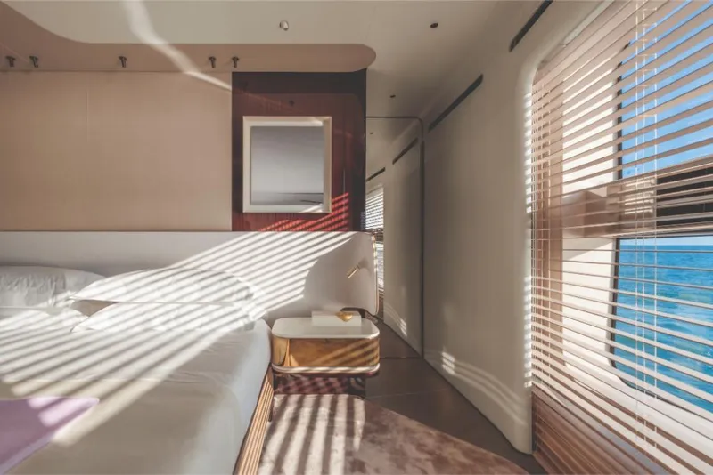 Slide: The Image of Luxurious bedroom interior of 2023 Azimut Trideck yacht with ocean view through blinds. - 44