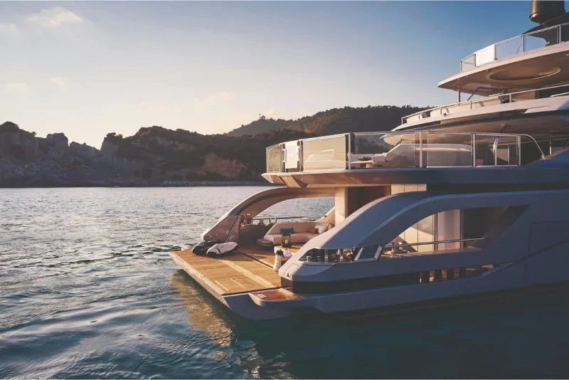 Slide: The Image of 2023 Azimut Trideck luxury yacht on serene waters at sunset. - 8