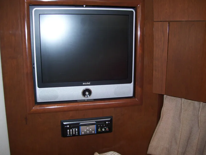 Slide: The Image of Flat-screen TV and control panel in 2007 Carver 43 Motor Yacht interior. - 19