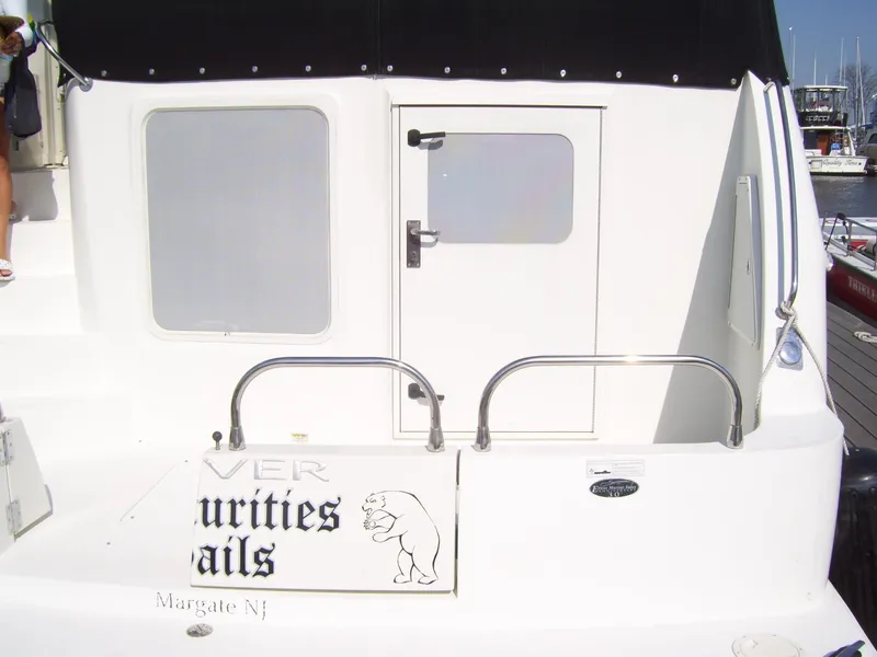 Slide: The Image of 2007 Carver 43 Motor Yacht stern with door and custom signage, docked in Margate, NJ. - 3