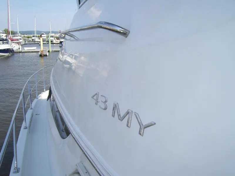 Slide: The Image of 2007 Carver 43 Motor Yacht docked at marina, side view with "43 MY" emblem. - 5