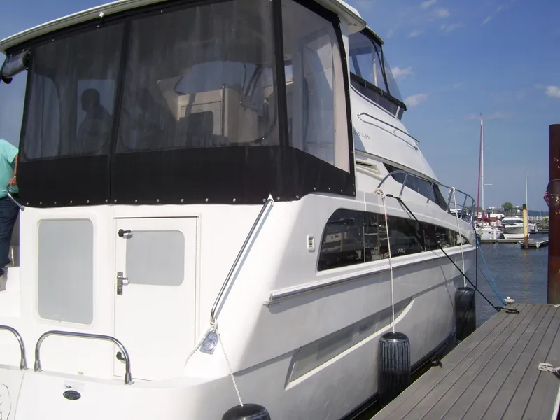 Slide: The Image of 2007 Carver 43 Motor Yacht docked at marina, featuring sleek design and spacious upper deck. - 1