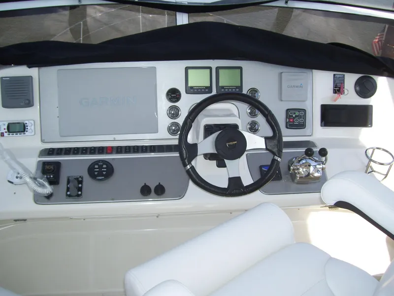 Slide: The Image of 2007 Carver 43 Motor Yacht helm with steering wheel and navigation instruments. - 10
