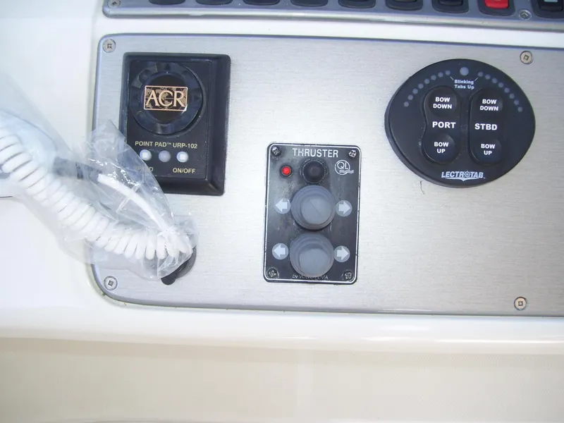 Slide: The Image of Control panel of a 2007 Carver 43 Motor Yacht with thruster and navigation controls. - 11