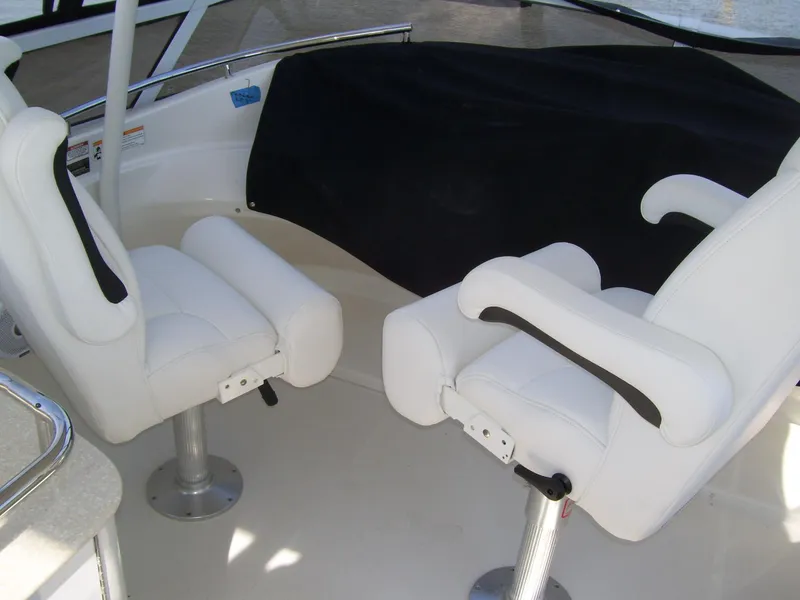 Slide: The Image of 2007 Carver 43 Motor Yacht interior with white captain chairs and covered dashboard. - 12