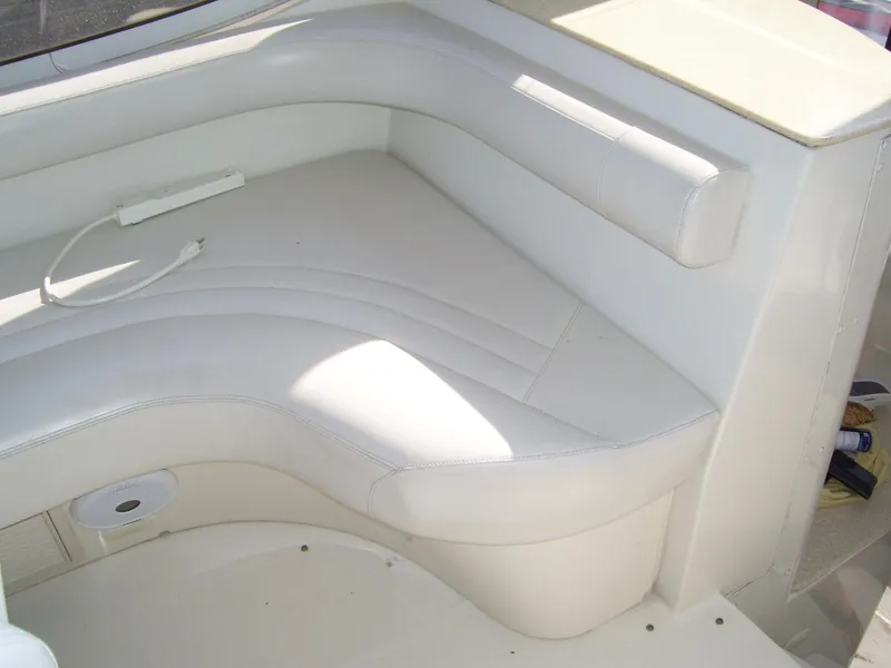 Slide: The Image of 2007 Carver 43 Motor Yacht interior seating, featuring white cushioned corner bench. - 13