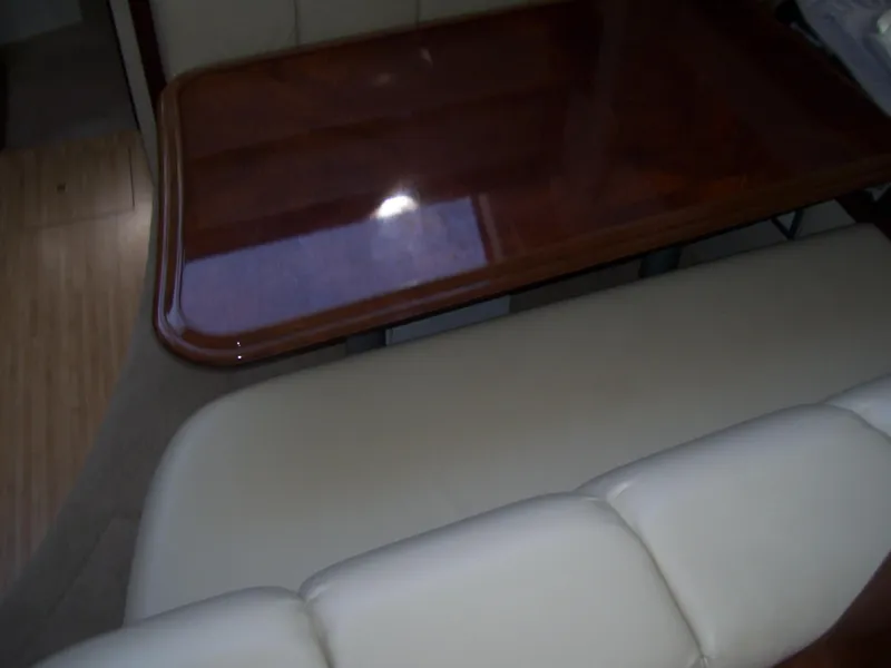 Slide: The Image of Interior of 2007 Carver 43 Motor Yacht with wooden table and beige seating. - 15