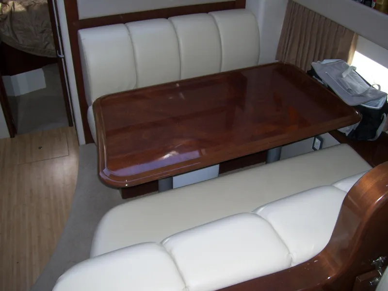 Slide: The Image of 2007 Carver 43 Motor Yacht interior with elegant dining area and plush seating. - 16