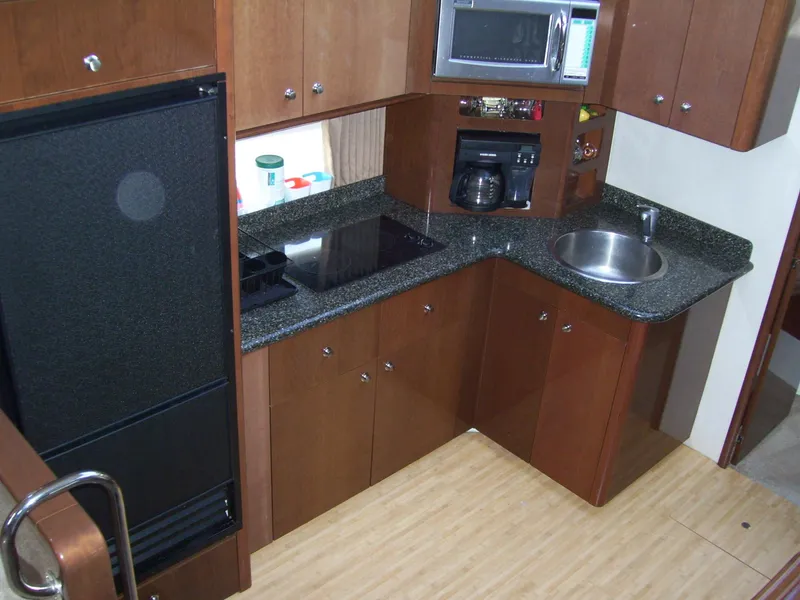 Slide: The Image of 2007 Carver 43 Motor Yacht kitchen with modern appliances and sleek countertops. - 20