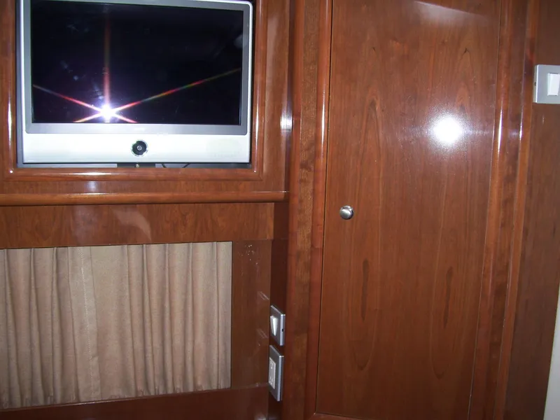 Slide: The Image of Interior of 2007 Carver 43 Motor Yacht with TV and wooden cabinetry. - 24