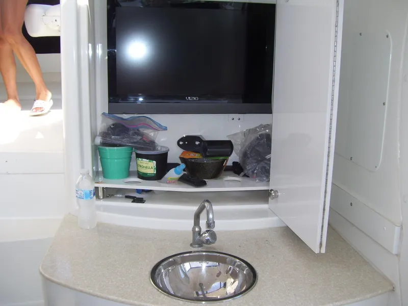 Slide: The Image of 2007 Carver 43 Motor Yacht interior with sink, TV, and storage cabinet. - 8
