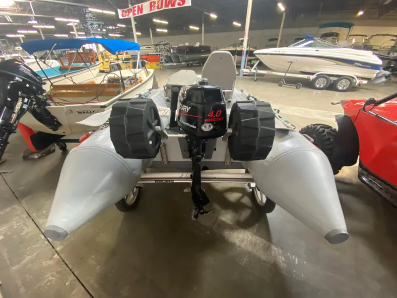 Slide: The Image of Inflatable Achilles LSI-112 boat with Mercury 4.0 motor in a showroom, 2006 model. - 3