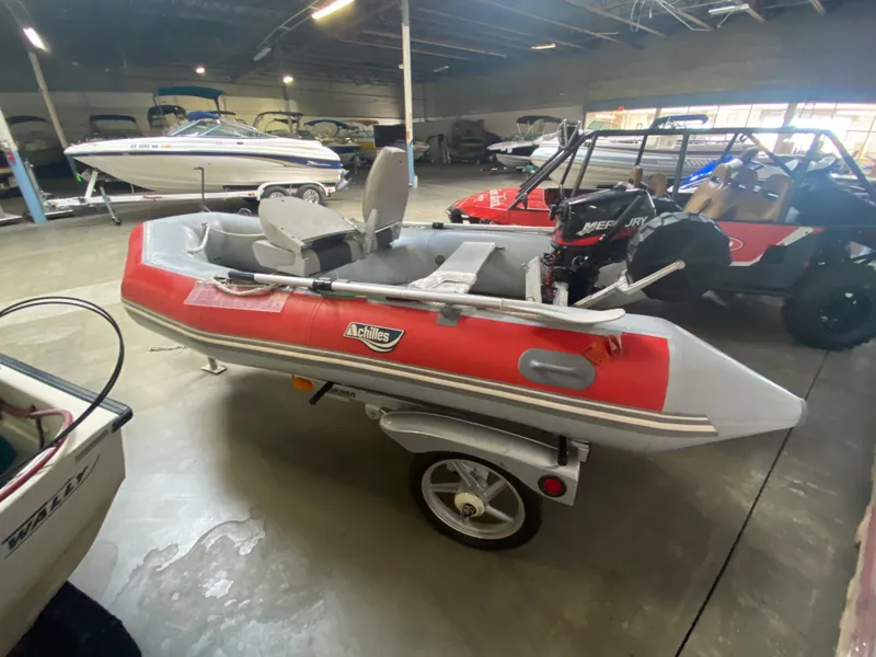 Slide: The Image of 2006 Achilles LSI-112 inflatable boat on trailer in showroom. - 4